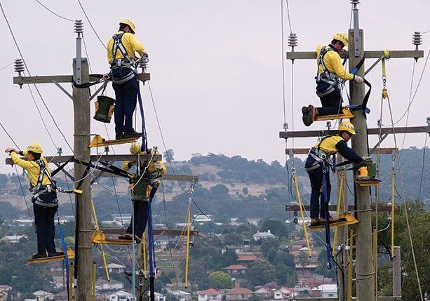 A group of men working on power lines.